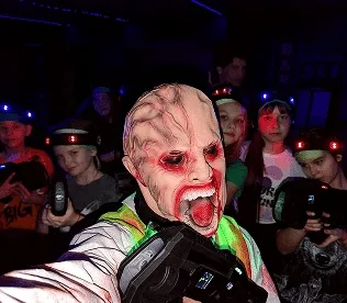 Група дорослих у камуфляжних жилетах грають у лазертаг